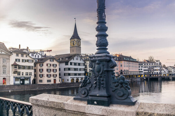 View of the riverside of the Limmat and the deserted old town of Zurich during the Coronavirus lockdown at sunset