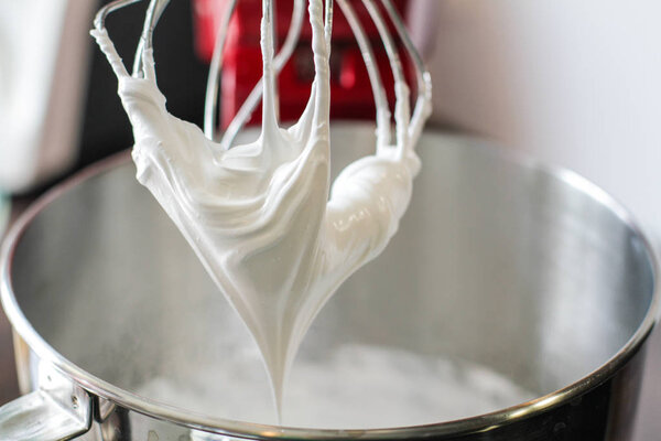 Whisk full of white cream