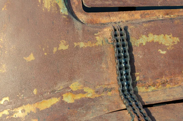rusty background. on rusty metal is an old motor chain. time concept. old gear