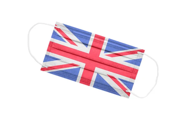 白地に英国国旗が描かれた医療用マスク イギリスのパンデミックの概念 英国でのコロナウイルス発生の属性 イギリスの医学 — ストック写真