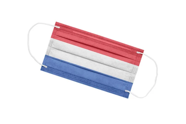 Medical face mask with flag of netherlands isolated on a white background. pandemic concept in the Netherlands. attribute of coronavirus outbreak in the Netherlands. Medicine in the Netherlands.