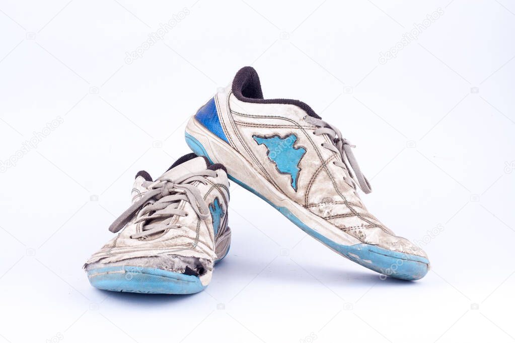 Old vintage damaged futsal sports shoes  on white background  isolated 