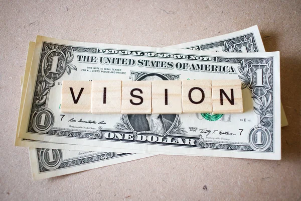 Träblock ordet vision och Dollar sedel — Stockfoto
