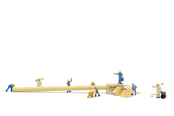 Miniature worker team sharpening a pencil — Stock Photo, Image