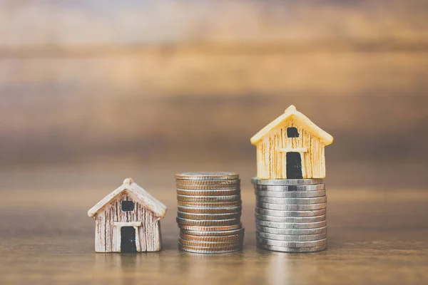 Sikke para ve ev ahşap arka plan üzerinde model 