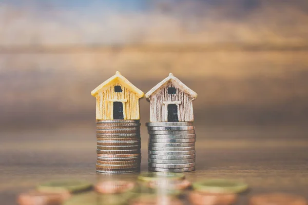 Coin money and house model on wooden background — Stock Photo, Image