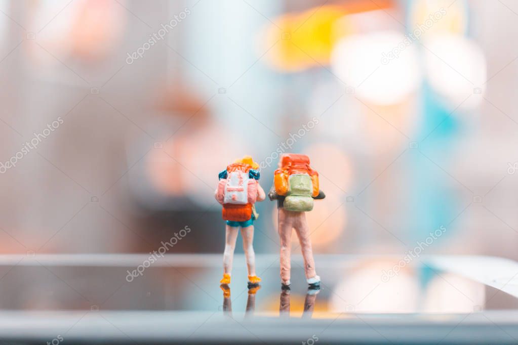 Miniature backpacker , Tourist people standing on smartphone 