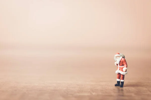 Miniature people Santa Claus carrying bag — Stock Photo, Image