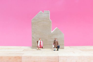 Evi pembe bir arka plan üzerinde çift , 