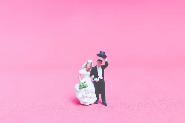 Bride and groom on pink background Stock Photo