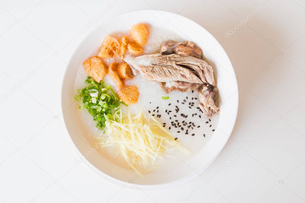 Pork porridge with ginger and coriander in bowl.