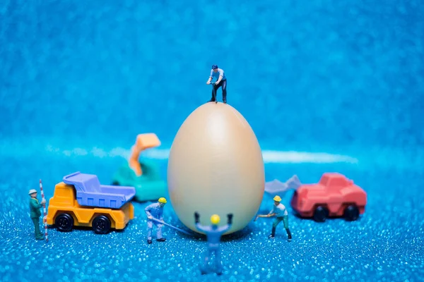 As pessoas em miniatura trabalham em Easter-eggs para o dia de Páscoa — Fotografia de Stock