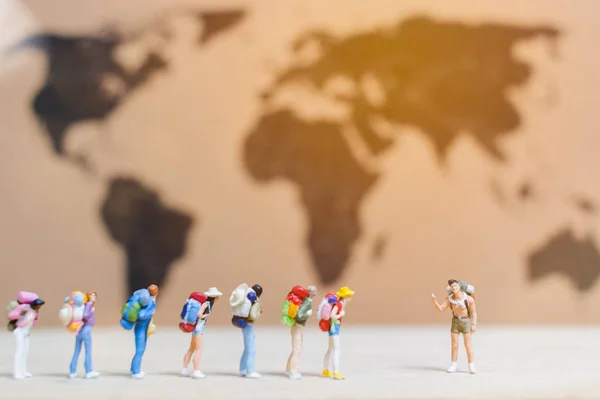 stock image Miniature people travelers walking on world map ,