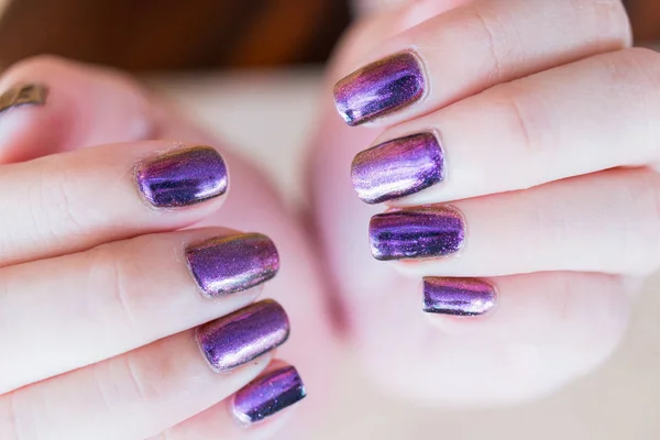 Beautiful nail polish in hand, Purple nail art manicure