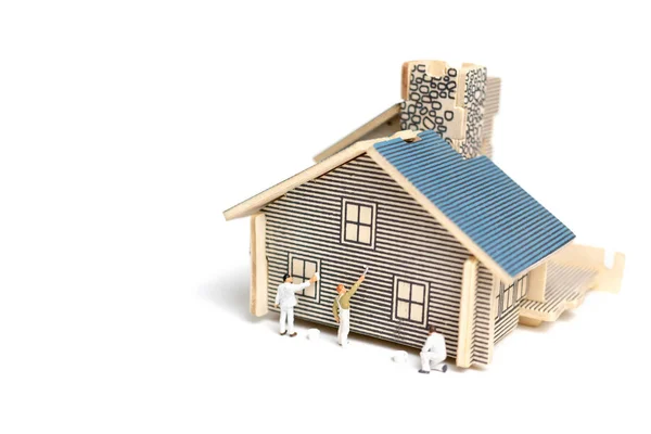 Miniaturowe osób: Pędzel malarstwo drewniany dom — Zdjęcie stockowe