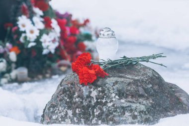 Memorial flowers. Red carnations on the stone in memory of the war. World War II, the Great Patriotic War, wreaths and carnations. clipart