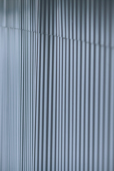 Abstract background, a fence of metal sheets. Metal rolling, metal profile, blurred texture with copy space.
