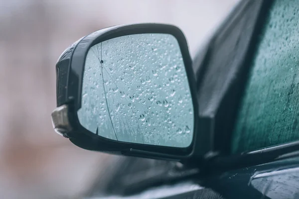 Car, rear view mirror. A foggy wet mirror in the rain.