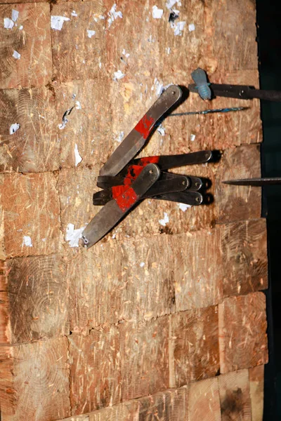 Throwing knives in the board. Close-up
