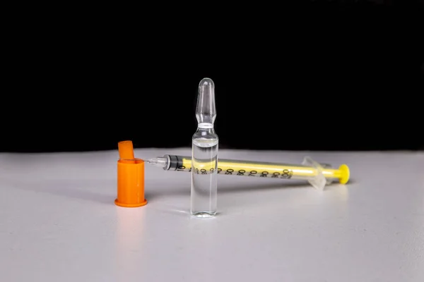 Insulin syringe with vial on a light table