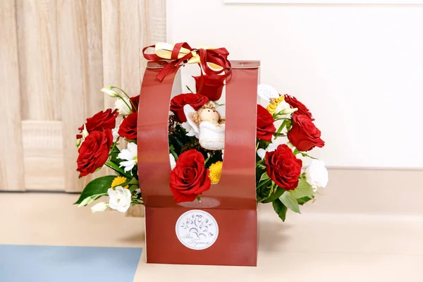 A bouquet of roses in a gift box