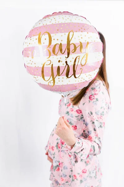 Young pregnant woman is holding pink balloons - Gender Reveal - — Stockfoto