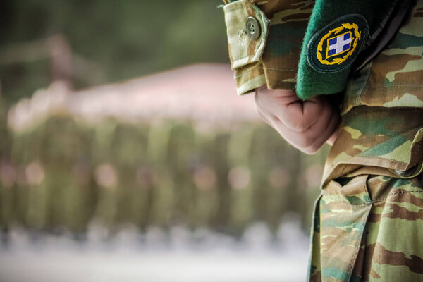 officers hand holding beret during oath in Greek army