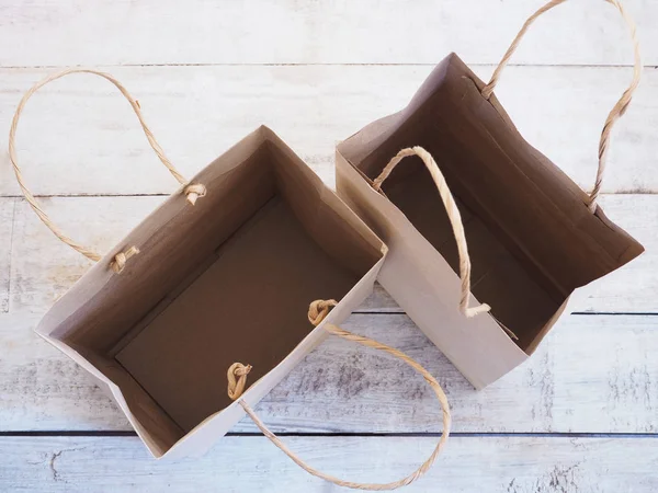 Bolsa de compras marrón vacía sobre fondo de madera — Foto de Stock