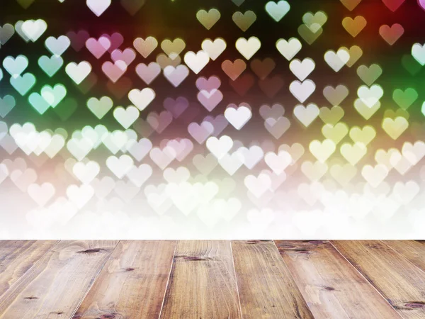 Wooden table on heart bokeh for Valentine's day background — Stock Photo, Image