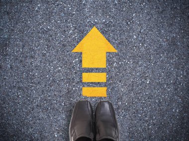 Sarı ok çizgisi ile beton yol üzerinde Selfie spor ayakkabı siyah ayakkabı