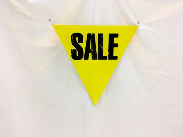 Yellow banner with black wording SALE on cotton fabric  backgrou — Stock Photo, Image