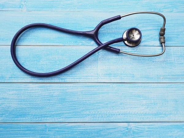 Stethoscope on blue wood background — Stock Photo, Image