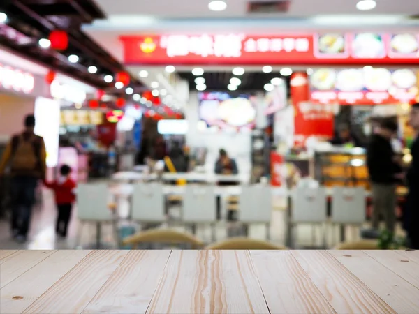 Wood table top over Chinese noodle restaurant blur background. — ストック写真