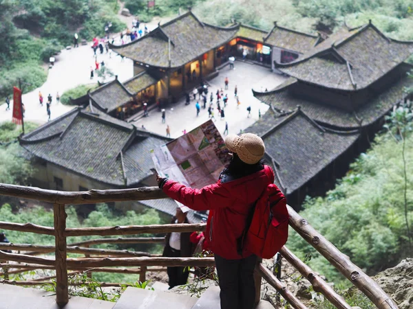 Asian tourist woman looking to the map at UNESCO world heritage — стокове фото