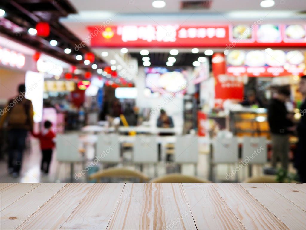 Wood table top over Chinese noodle restaurant blur background. 