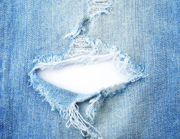 Ripped torn pattern of light blue denim jeans on white backgroun — 스톡 사진