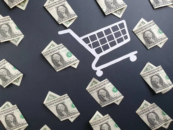 american one dollar bills and white shopping cart on the black background