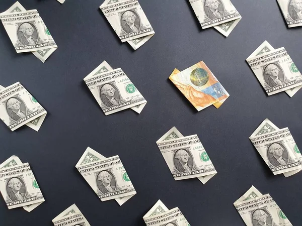 american one dollar bills and swiss banknote of ten francs on the black background