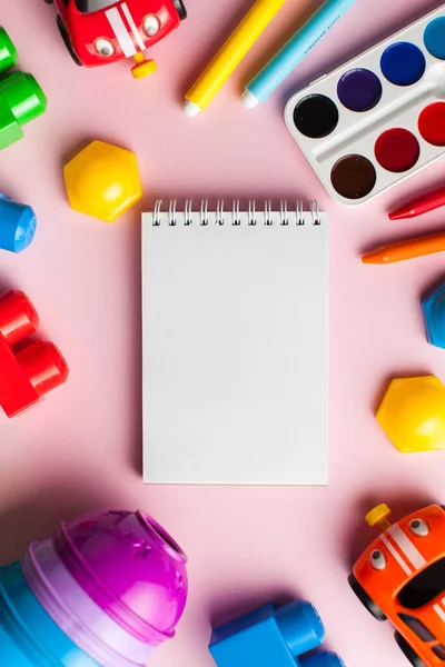 Kids flatlay. Children\'s designer, cars, pyramid on a colored background. The concept of development and parenting. designer, sorter, creative. Leisure and hobbies of the child. Copy space.