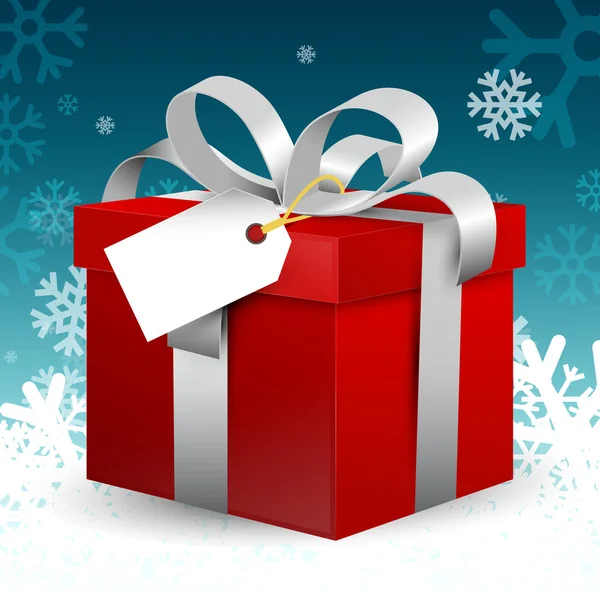 Caja de regalo roja con cinta de plata y etiqueta de papel vacía en fondo azul de invierno con copos de nieve. Decoración de Navidad VEctor . — Archivo Imágenes Vectoriales