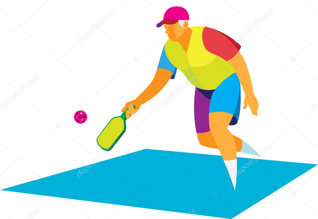 Energetic elderly man playing on a court with a racket and ball