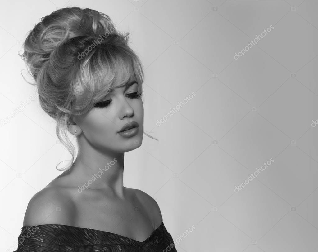 portrait of a beautiful blonde woman in retro dress 50-s style . copy space. vintage look. babetta haircut. monochrome black and white photo