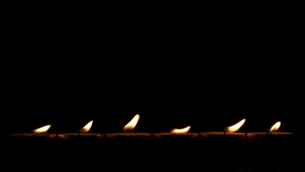 Six small candles in dark. Close up — Stock Video