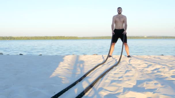 Battle ropes on the river bank — Stock Video