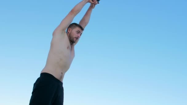 Homem atlético levanta halteres pesados — Vídeo de Stock