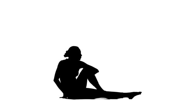 Girl shows the pose turns to the side. Silhouette — Stock Video