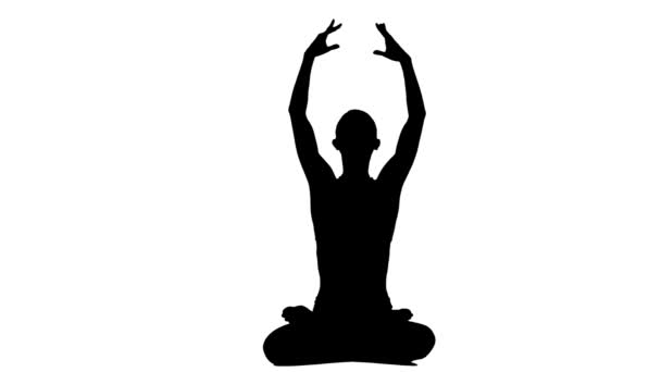 Silhouette woman meditating in a yoga pose. White background. Silhouette — Stock Video