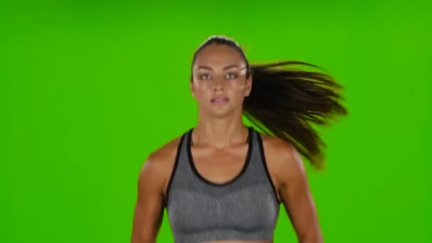 Female runner with a slender figure is running. Front view. Green screen — ストック動画