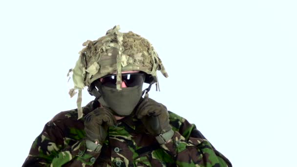 Soldier wears a helmet on his head. White backgraund — Stock Video