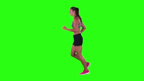 Woman jogging in a medium frontal shot. Green screen. Slow motion — Stock video